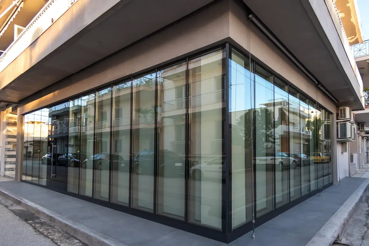 The TPL S.A. offices on Ethnomartyron 40, Patras: a corner ground floor glazed floor-to-ceiling on both street faces