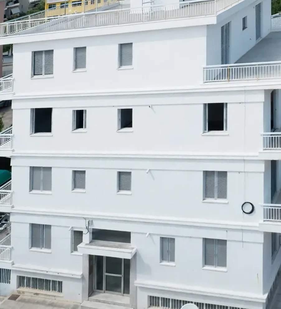 Photo of the building's front facade today, perspective-corrected to match the concept render