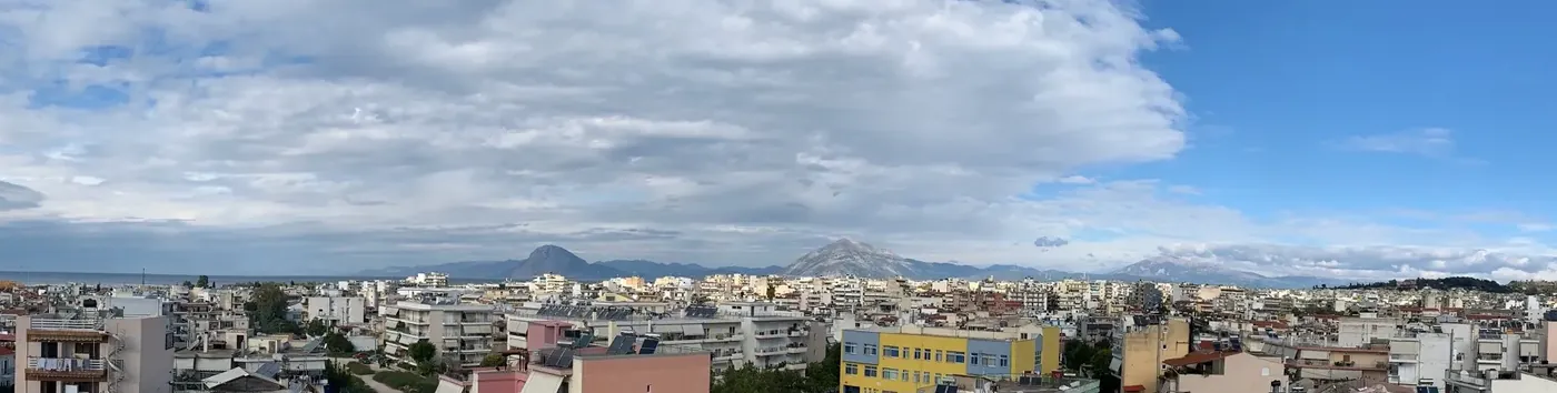 Photo from the roof of the building across the rooftops of south Patras to the gulf and the mountains